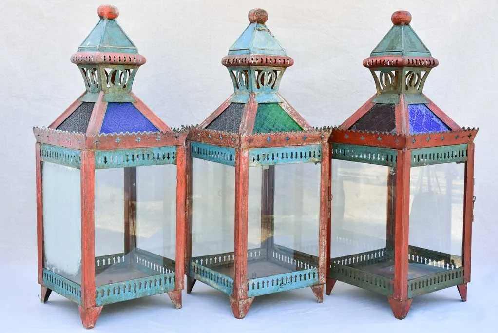 Three large lanterns with colored glass